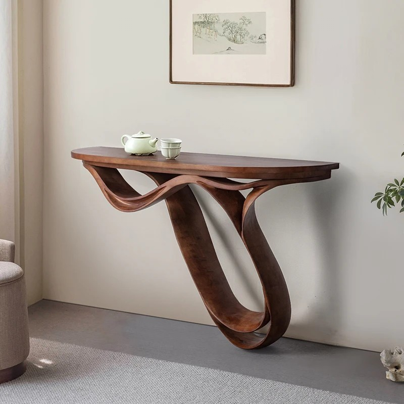 Wooden console table with wavy leg design in a room setting.