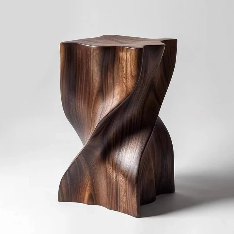 Wooden stool with a unique, twisted design on a white background