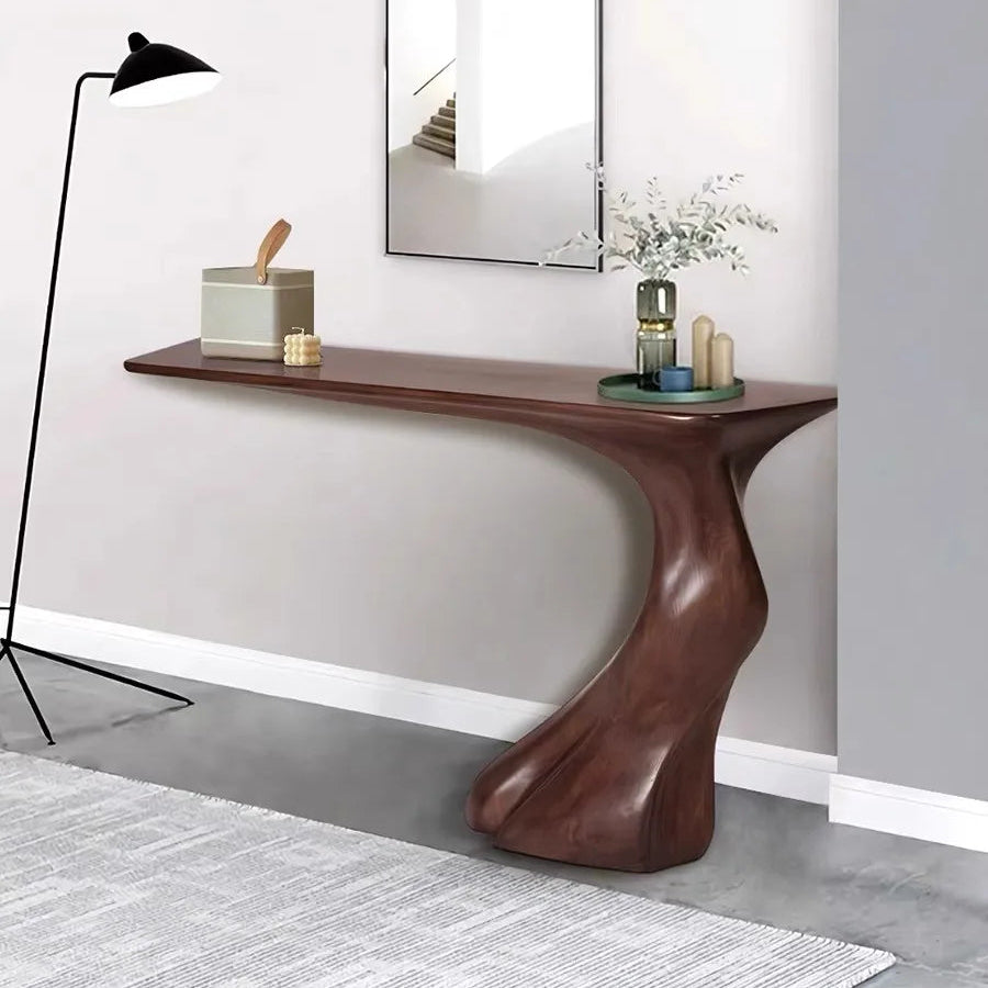 Wooden console table against a gray wall with decorative items.