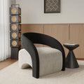 Modern black and white chair in a room with wooden paneling and decorative elements.