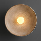 Desert Scandi wall lamp with a minimalist metal design and warm white LED lighting for modern bedrooms and living spaces.