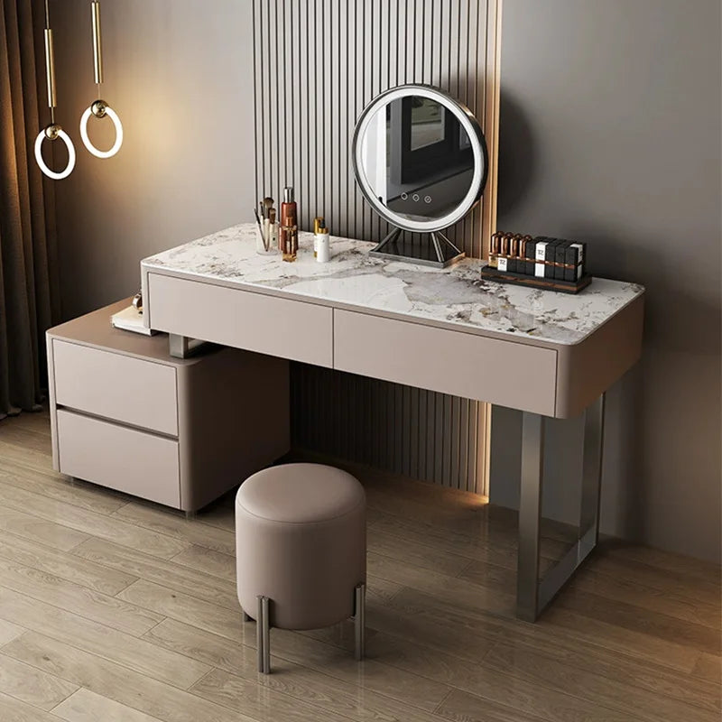 Dressing table with marble top, mirror, and stool in a room setting.