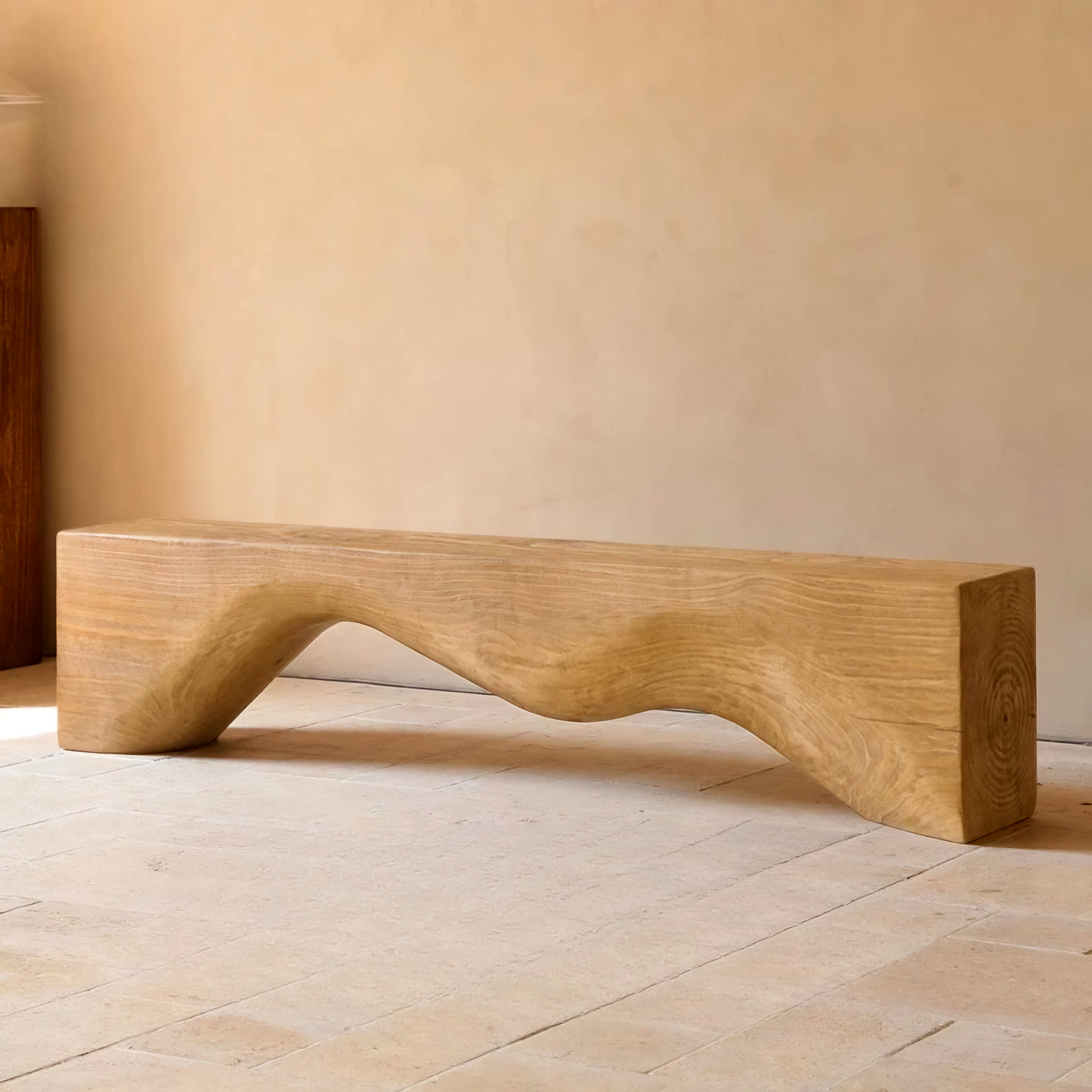 Wooden bench with a curved design on a light wooden floor.