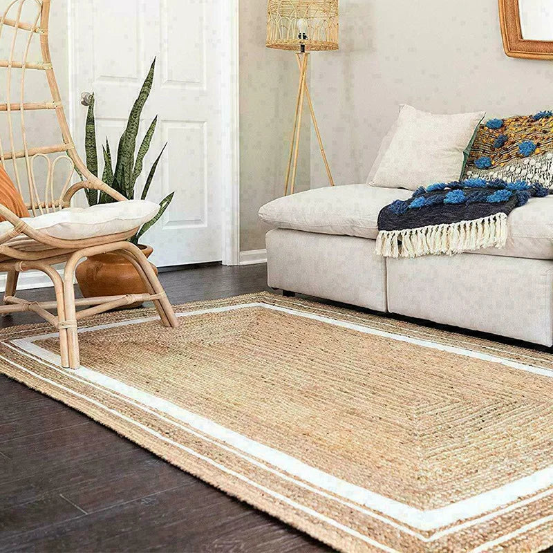 Living room with a jute rug, beige sofa, and decorative chair.