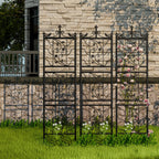 Decorative metal trellis with floral design against a stone wall