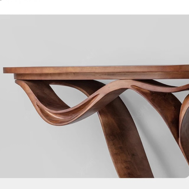 Wooden table with wavy leg design on a white background