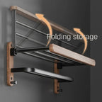 Wall-mounted folding storage rack with L-shaped design on a dark background