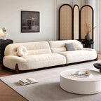 Modern living room with a white sofa, round coffee table, and decorative elements.