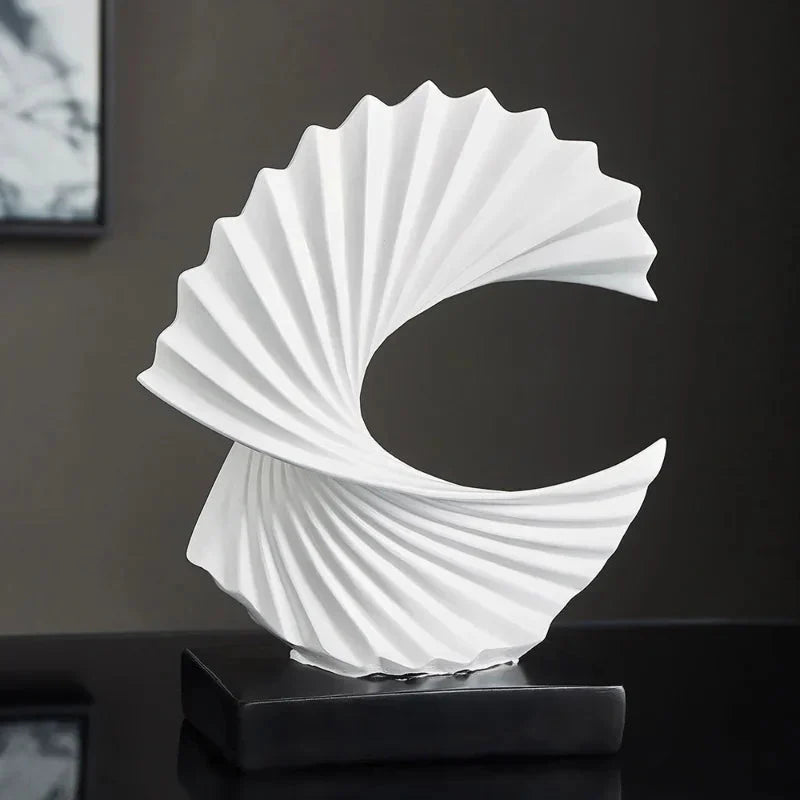 White decorative sculpture on a black base against a dark background