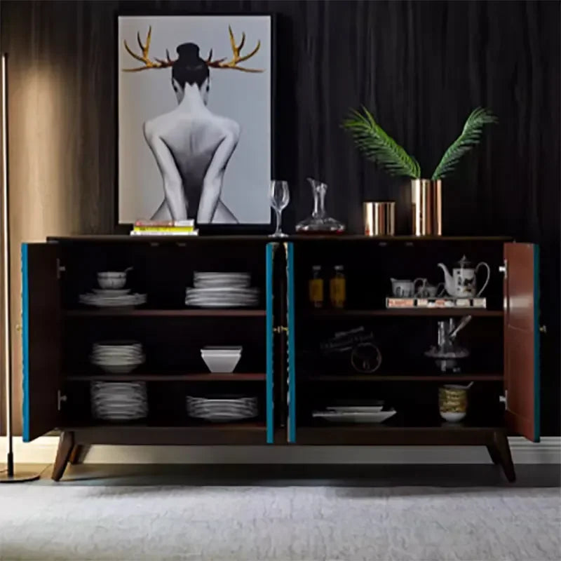 Wooden sideboard with decorative items in a room with a painting on the wall.
