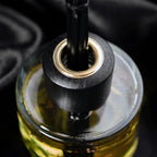Close-up of a black oil burner with a dark background