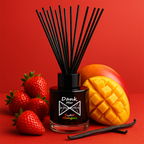 Diffuser with black sticks, strawberries, mango, and vanilla on a red background