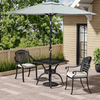 Outdoor patio set with table and chairs under a large umbrella on a wooden deck.