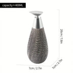Decorative bottle with textured design and silver cap, shown with measurements on a white background.