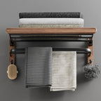 Towel rack with folded towels on a gray wall