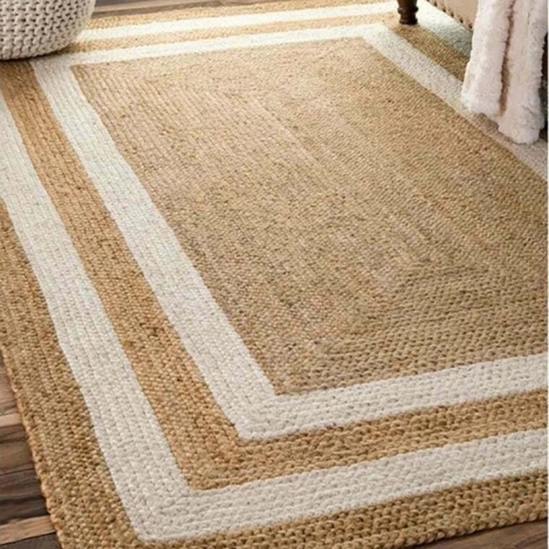 Beige and white geometric patterned rug on a wooden floor