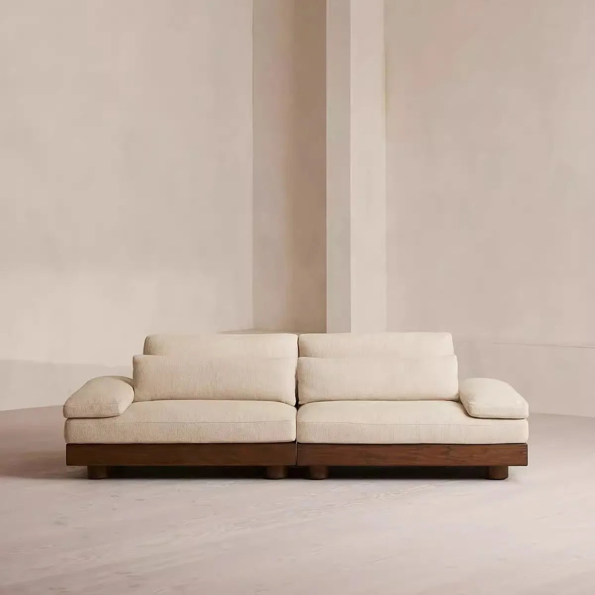 Modern white sofa against a plain wall