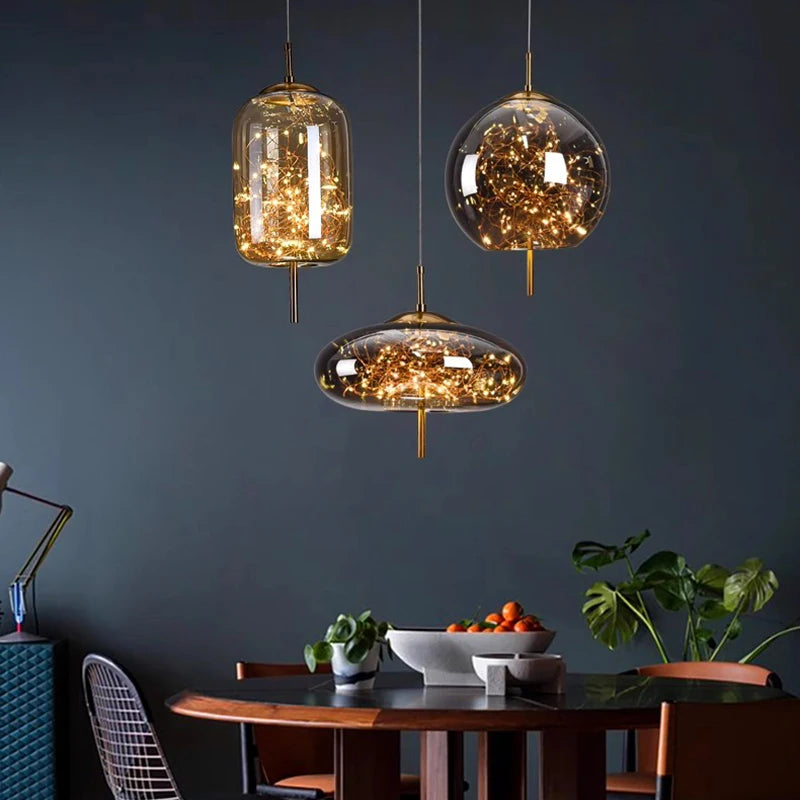 Modern dining room with glass pendant lights and a dark wall.