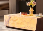 Marble coffee table with decorative items in a living room setting
