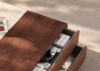 Wooden coffee table with open drawer on a textured surface