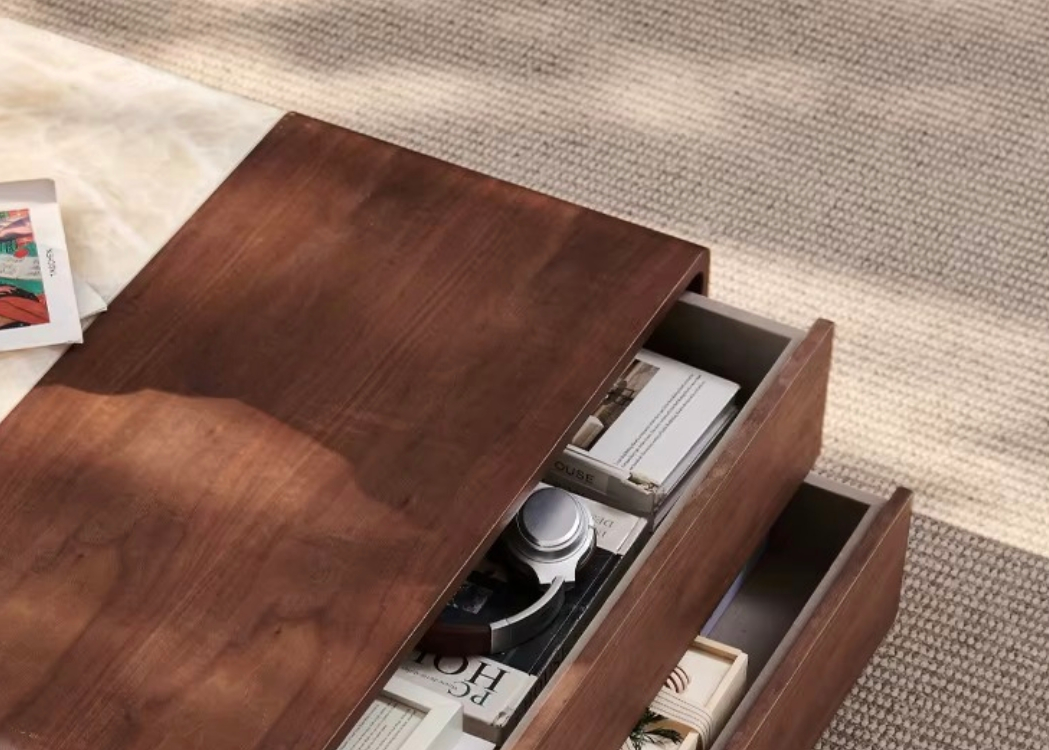 Wooden coffee table with open drawer on a textured surface