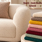 Bouclé lamb-fleece textured cream sofa with a matching cushion, alongside a stack of colourful bouclé fabric swatches in ivory, taupe, mustard, pink, burgundy, sage and teal.