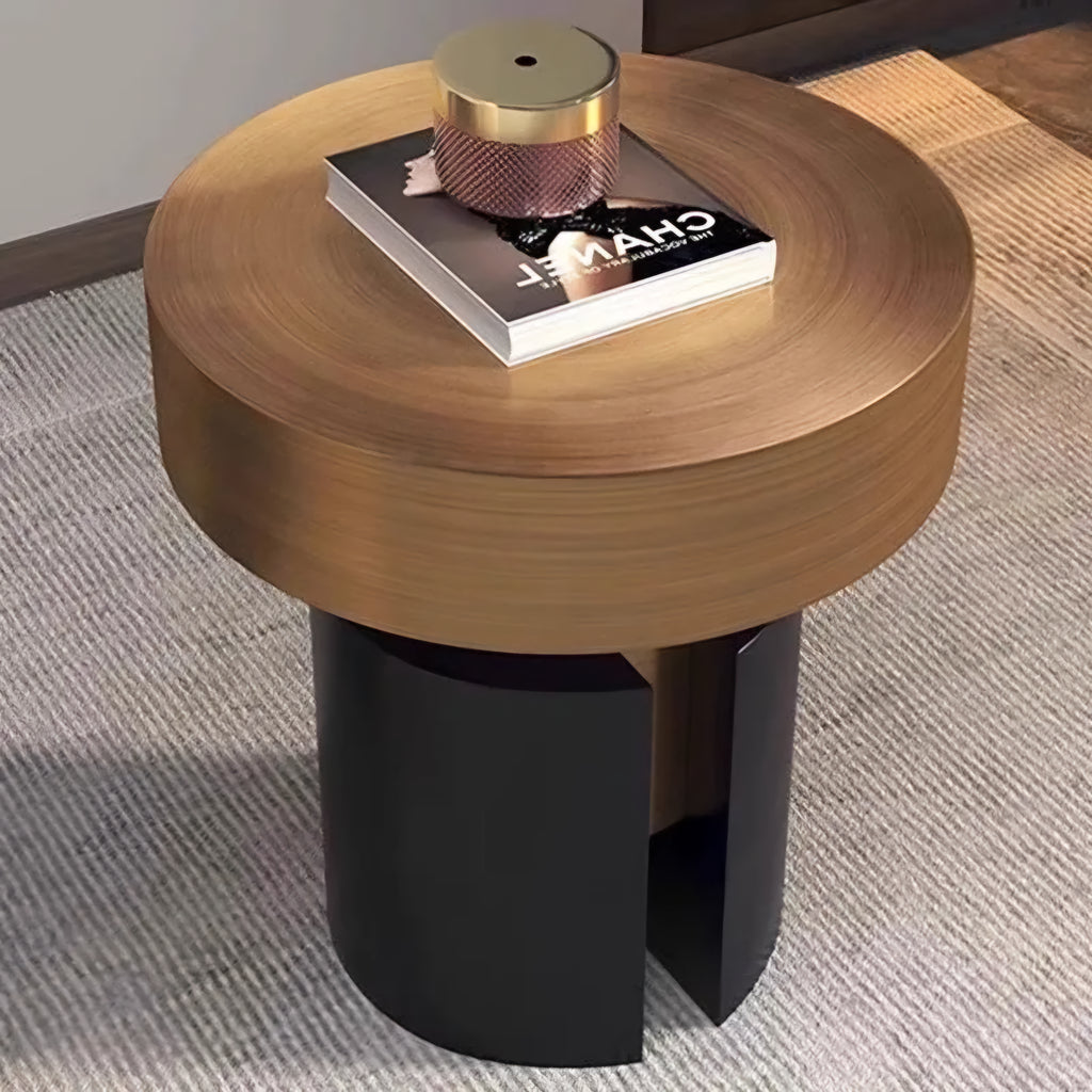 Round wooden side table with black base on a carpeted floor
