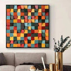 Colorful geometric wall art above a gray sofa in a living room.