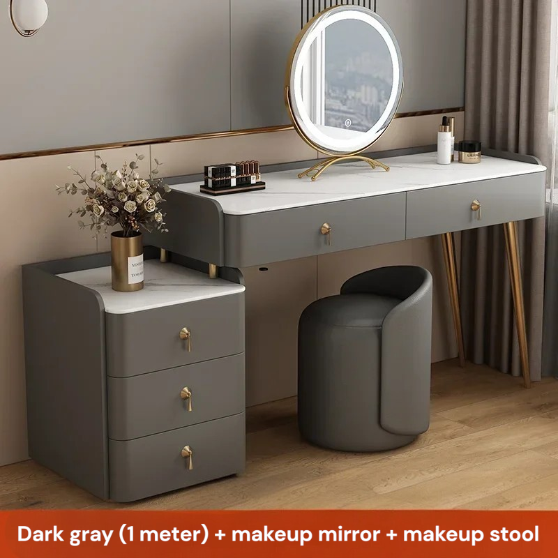 Gray vanity desk with round mirror and stool in a room setting