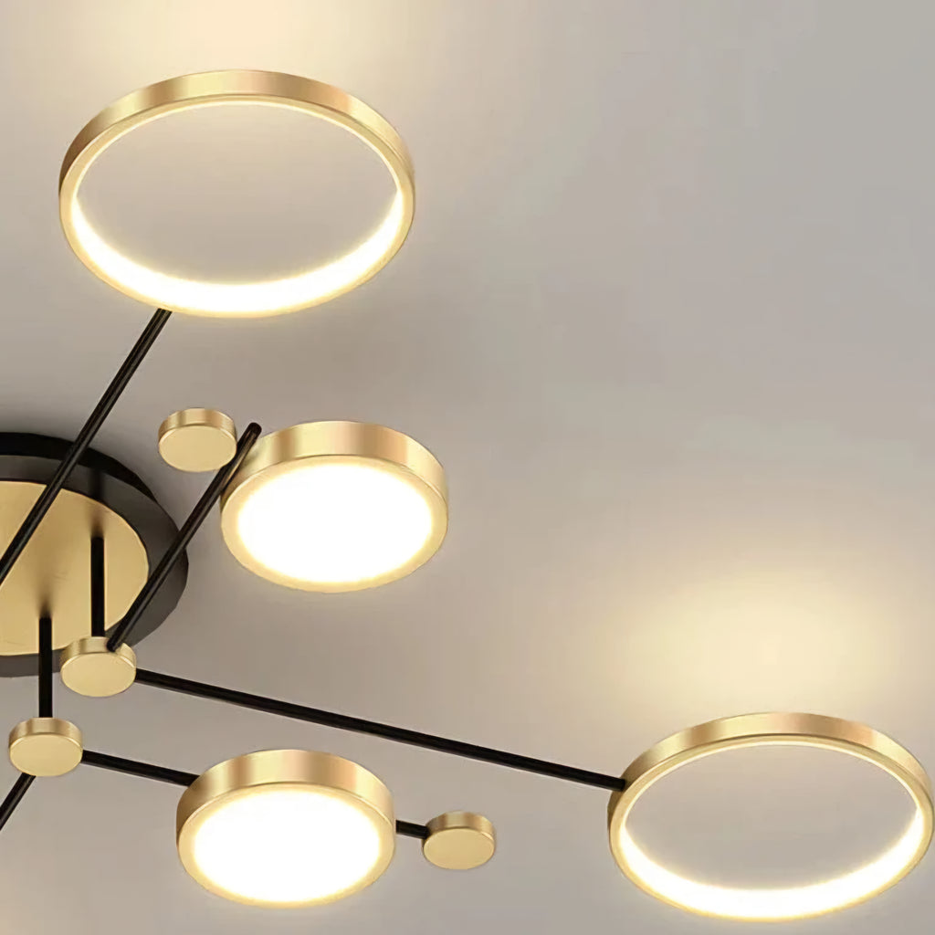 Modern chandelier with gold and black design on a neutral background