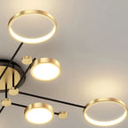 Modern chandelier with gold and black design on a neutral background