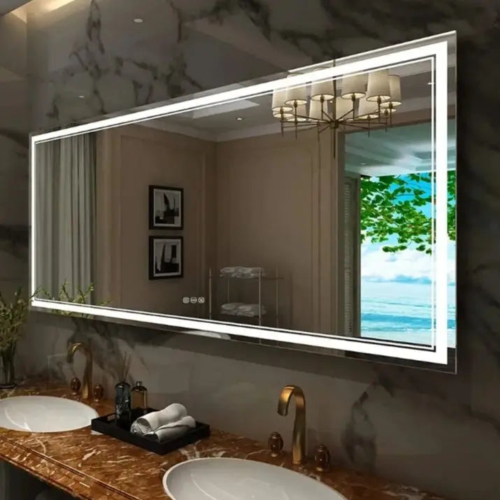 Bathroom with a large illuminated mirror above a double sink.