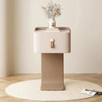 Modern side table with a vase of flowers on a wooden floor.