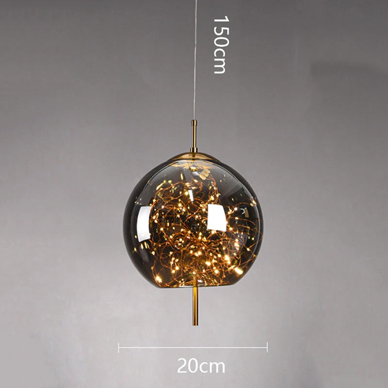 Pendant light with glass shade and gold accents on a gray background