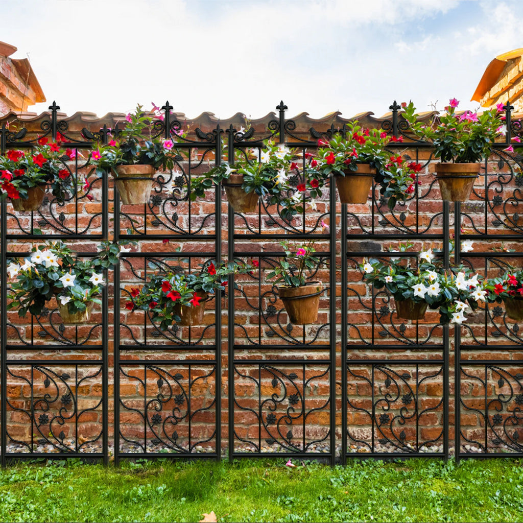 Decorative metal fence with floral pots on a brick wall