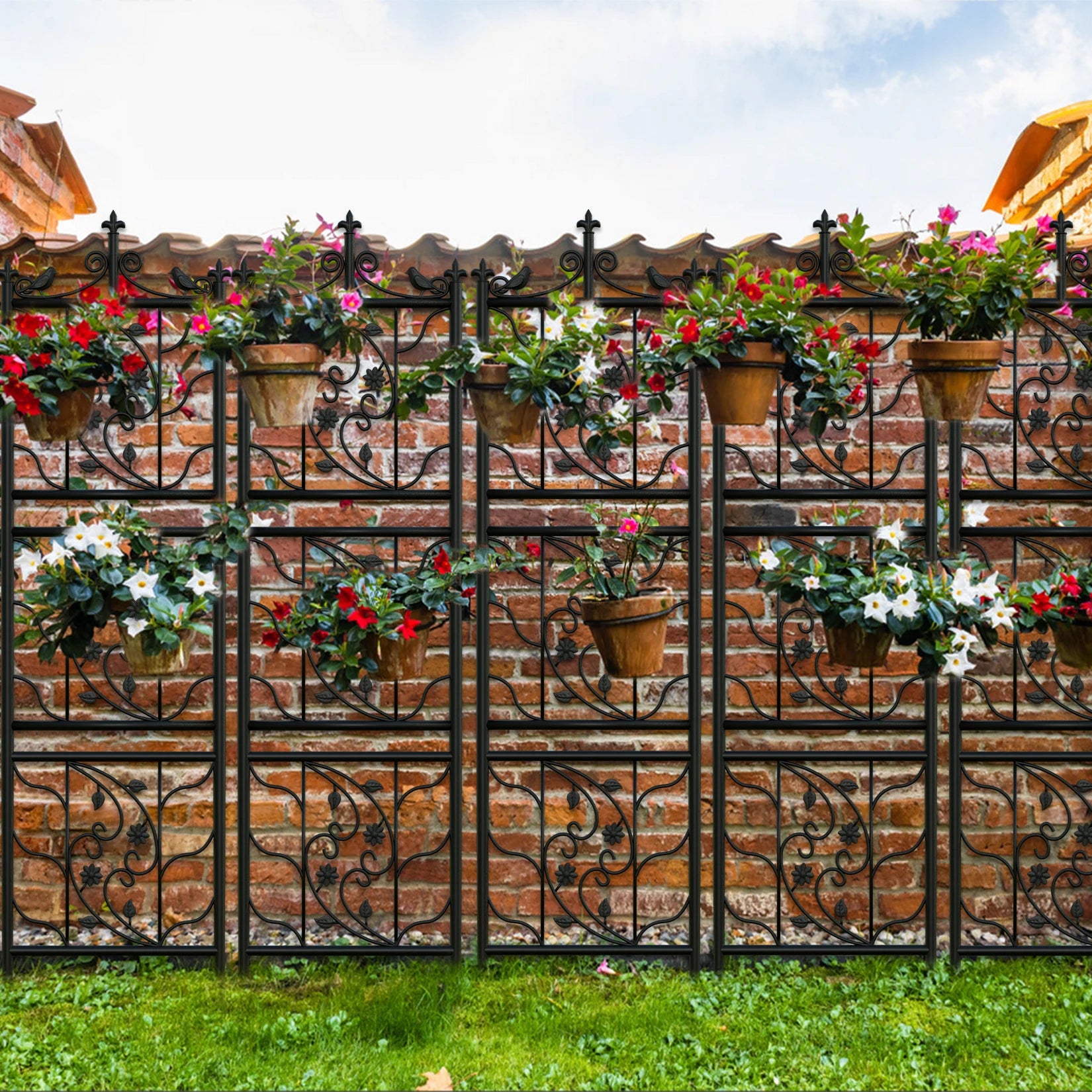 Decorative metal fence with floral pots on a brick wall