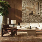 Modern living room with stone wall, wooden floor, and decorative elements.