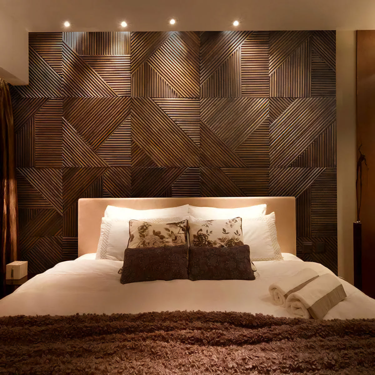 Bedroom with a wooden geometric headboard and neatly made bed.
