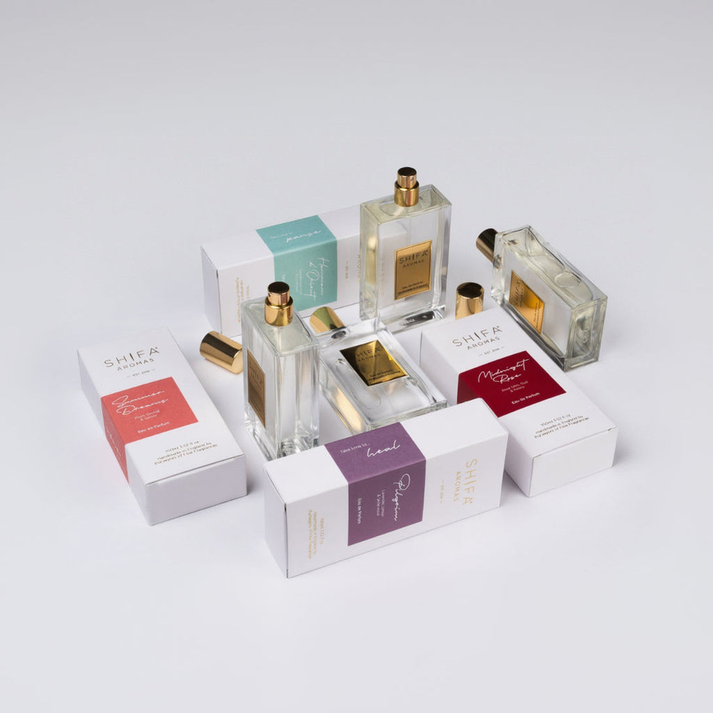 Collection of Shifa perfume bottles and boxes on a white background