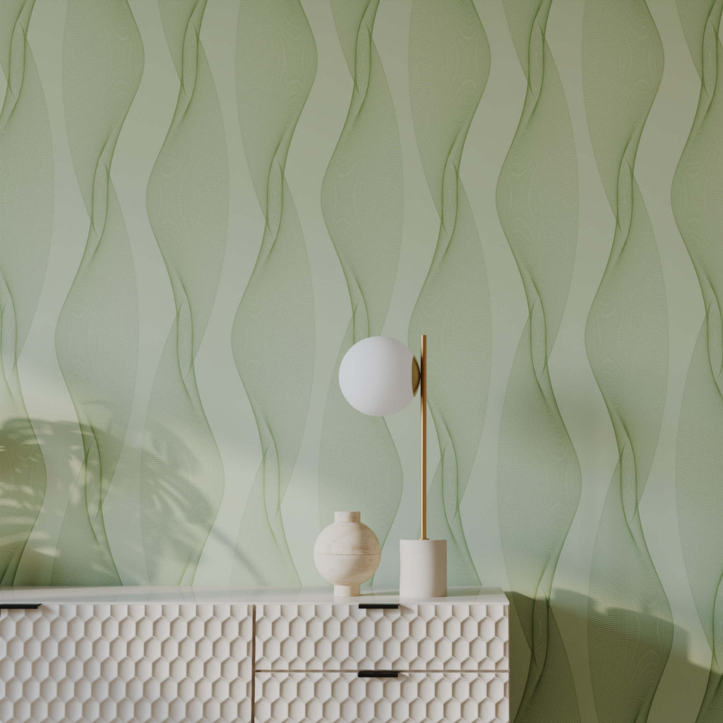 Decorative lamp and vase on a textured white console table against a green wavy patterned wall.