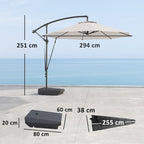 Beige patio umbrella with measurements on a concrete surface and blue sky background