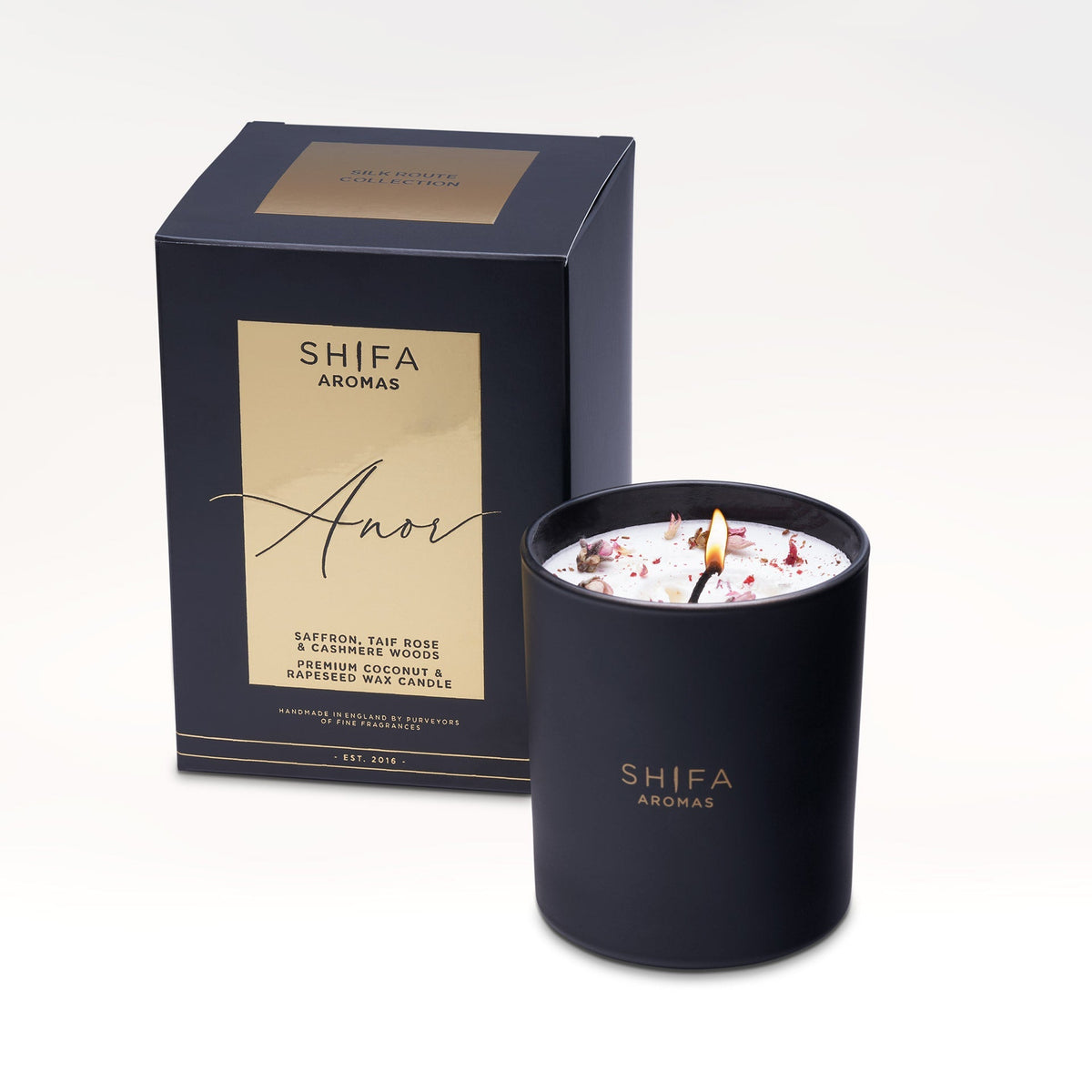 Black candle with 'Shifa Aromas' branding next to its packaging on a white background