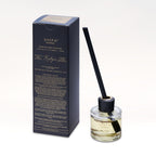 Scented diffuser bottle with black packaging on a white background