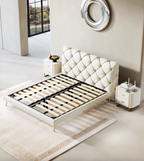 Modern bedroom with a white upholstered bed and matching nightstands.
