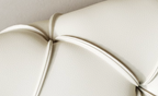 Close-up of a textured beige cushion with a soft focus background