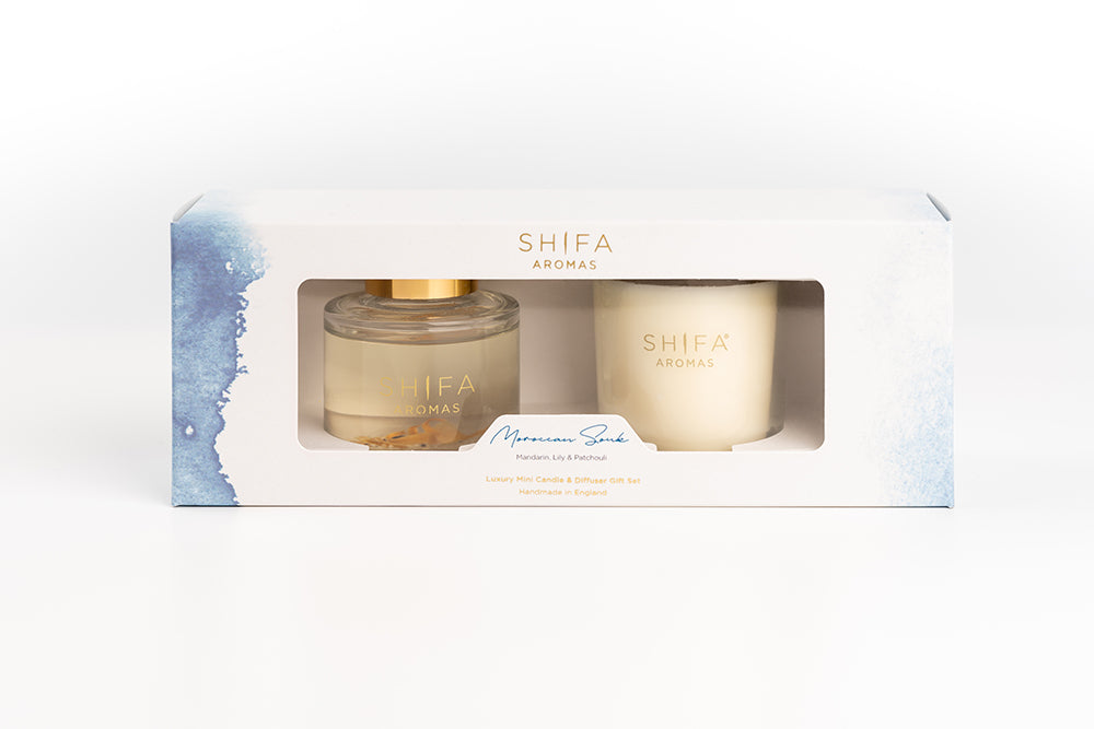 Two candles in a Shifa Aroma packaging on a white background