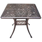 Decorative metal table with intricate patterns on a white background