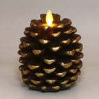 Decorative candle shaped like a pine cone with a lit flame on a plain background