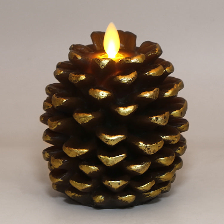 Decorative candle shaped like a pine cone with a lit flame on a plain background