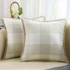 Two light gray velvet cushion covers with a solid pattern and visible texture, displayed on a neutral background.